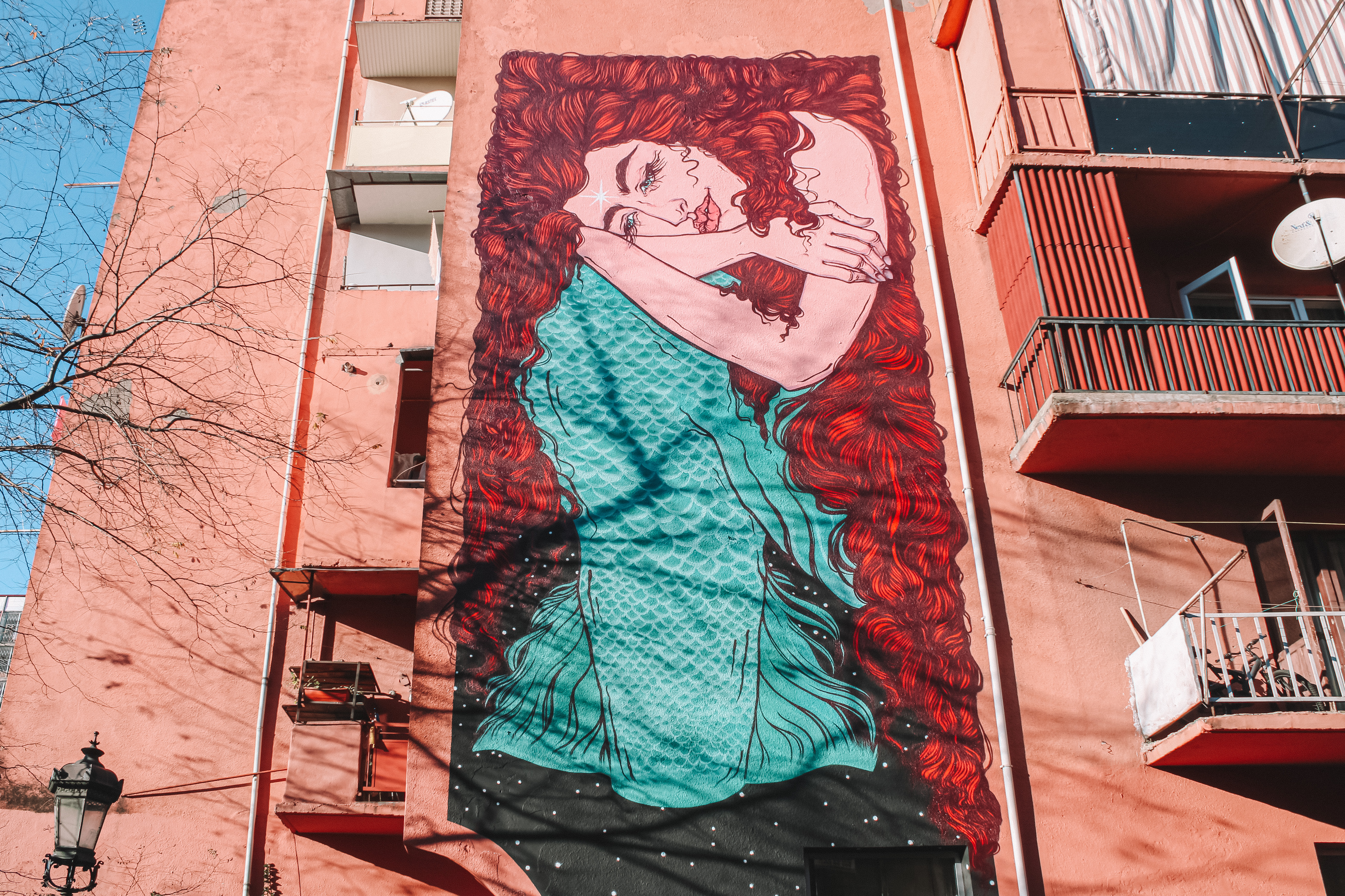 A mural showcasing a mermaid. It is located on a wall of an apartment building on Melashvili street.